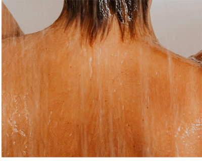 a woman's back in the shower, close up of skin