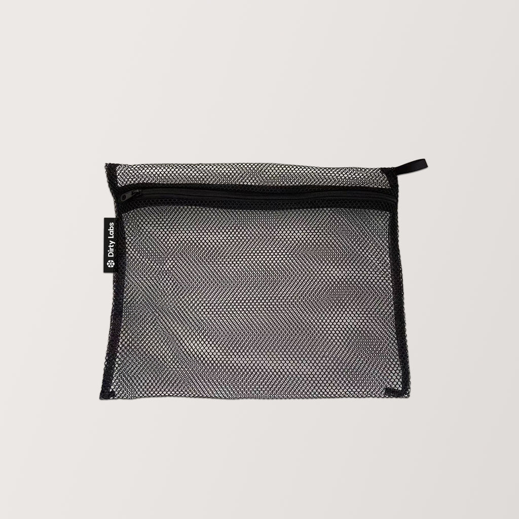 A black, rectangular mesh zippered pouch with a side tag, perfect for storing your Hand Wash & Delicates Bio Laundry Detergent + Free Gift, displayed on a plain light background.