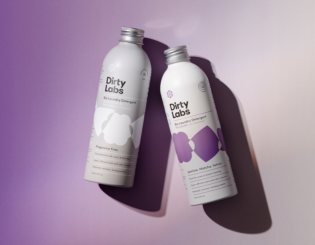 Murasaki and Hand Wash & Delicates Bio Enzyme Laundry Detergent bottles on purple gradient background