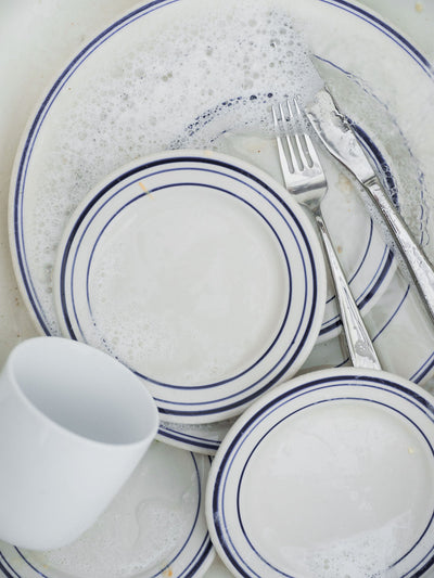 White plates soaking in water