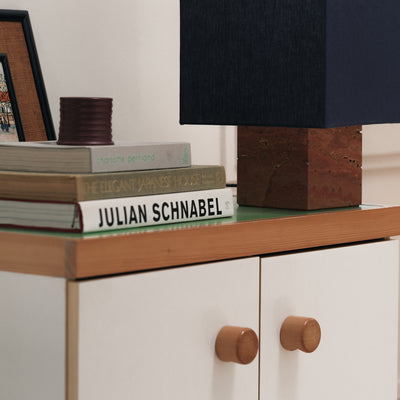 books on a nightstand with wood lamp