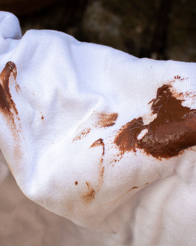 White fabric with chocolate stains on a dark background