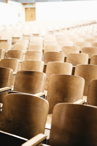 Row of wooden chairs in a room with blurred background