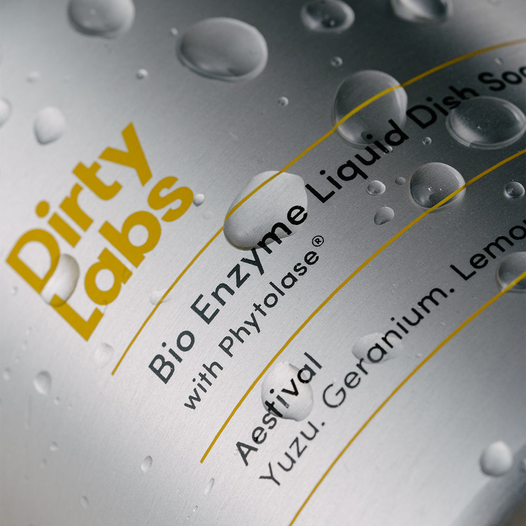 close up of Dirty Labs aluminum liquid dish soap bottle with water droplets resting on top.