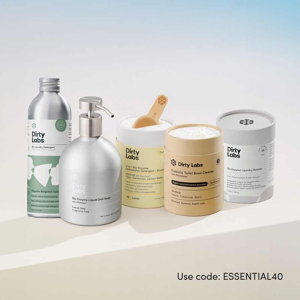 Collection of Dirty Labs cleaning products including 32 load signature detergent, bio enzyme liquid dish soap free and clear, aestival dishwasher detergent, probiotic toilet bowl cleaner, and bio enzyme laundry booster on a light background with promotional text: $100 value for $60
