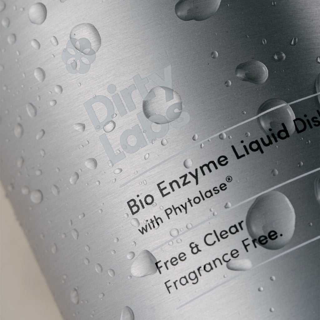 close up of Dirty Labs Free and Clear liquid dish soap aluminum bottle with water droplets.