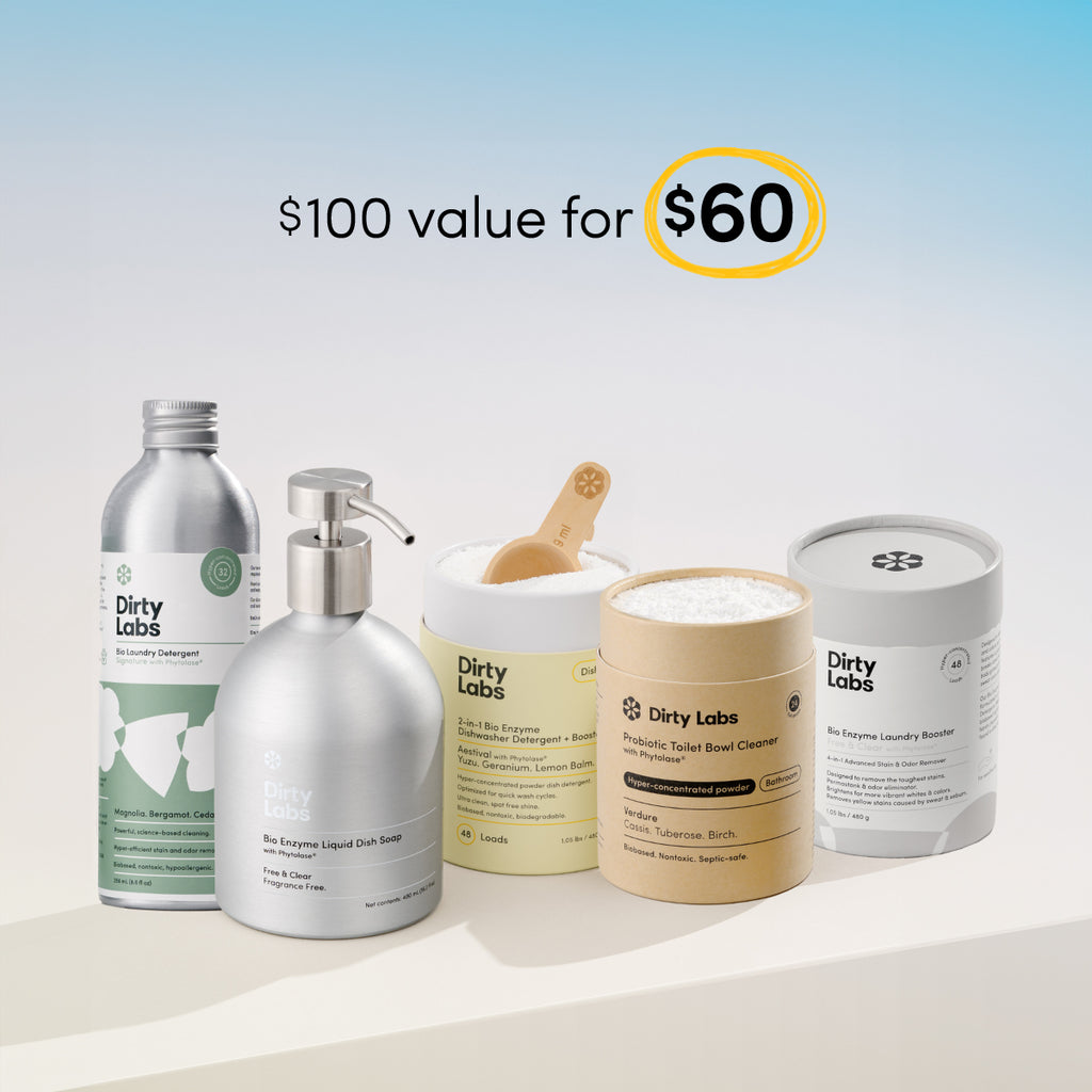 Collection of Dirty Labs cleaning products including 32 load signature detergent, bio enzyme liquid dish soap free and clear, aestival dishwasher detergent, probiotic toilet bowl cleaner, and bio enzyme laundry booster on a light background with promotional text: $100 value for $60