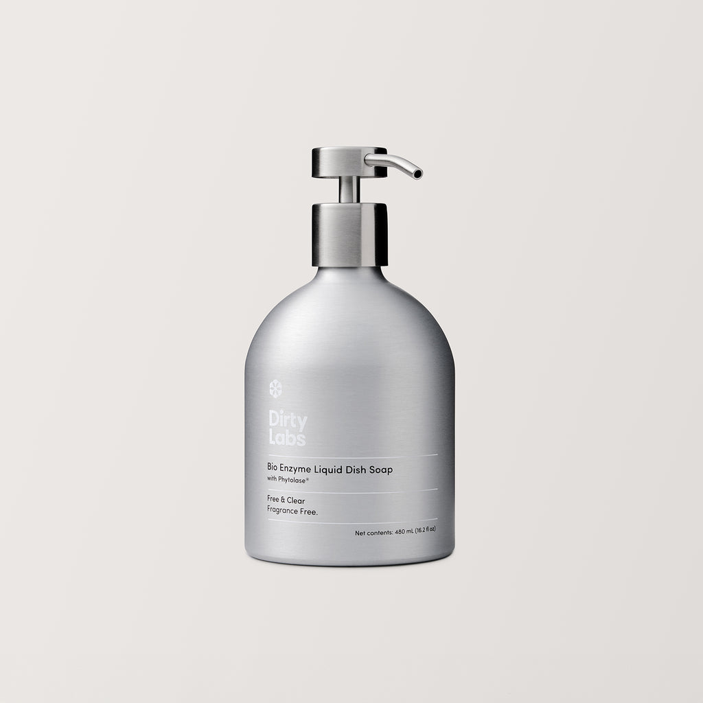 A silver pump bottle labeled Free & Clear Bio Enzyme Liquid Dish Soap stands against a plain light background, emphasizing its biodegradable formula.