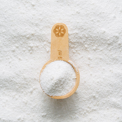 close up of powder toilet bowl cleaner in wooden scoop