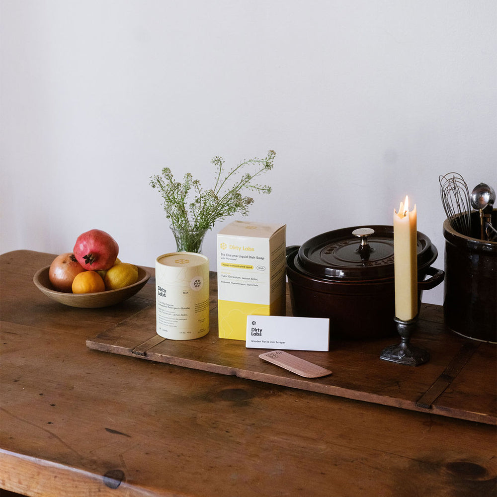 Wooden surface with a box, candle, and other items on a neutral background