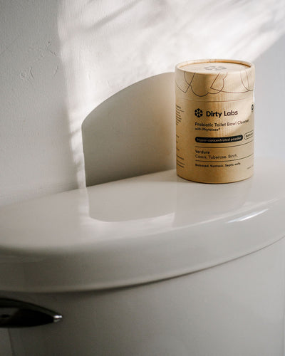 Dirty Labs toilet bowl cleaner on top of toilet close up